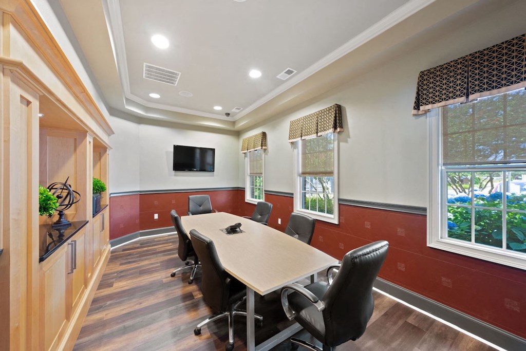 Fenwyck Manor's conference room with TV and conference tables and chairs