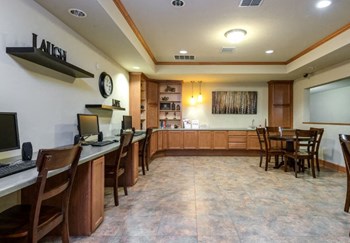 business center with computers, tables and chairs and sofa at The Point at Fairview Apartments, Prattville