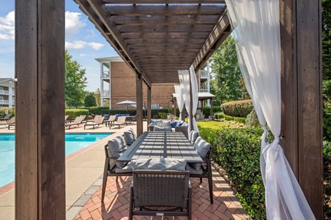 the covered outdoor dining and lounge area at Centerville Manor Apartments