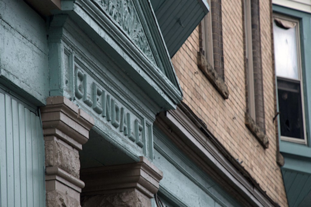 brick apartment building with a green and brown facade at 76 Grant St in Buffalo, NY