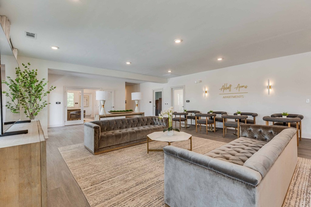 a living room with couches and a table with chairs