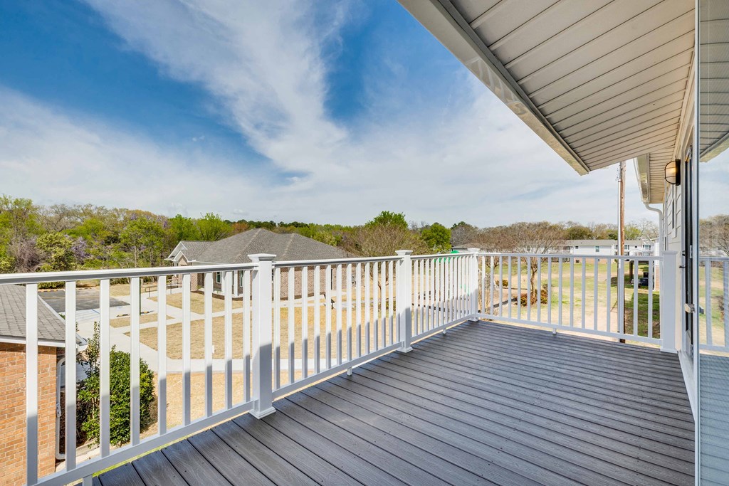 the view from the deck of a home with a white railing