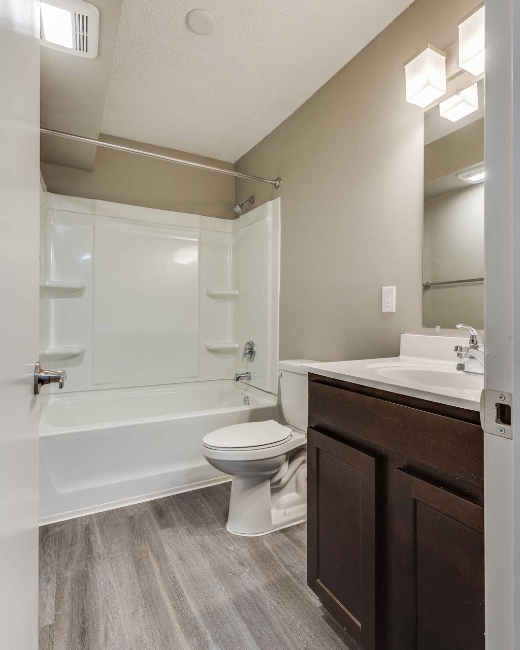 a bathroom with a toilet and a shower and a sink