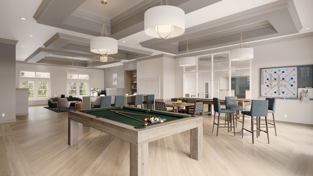 Archer Green's spacious community room with billiards, a kitchenette, and tables and chairs