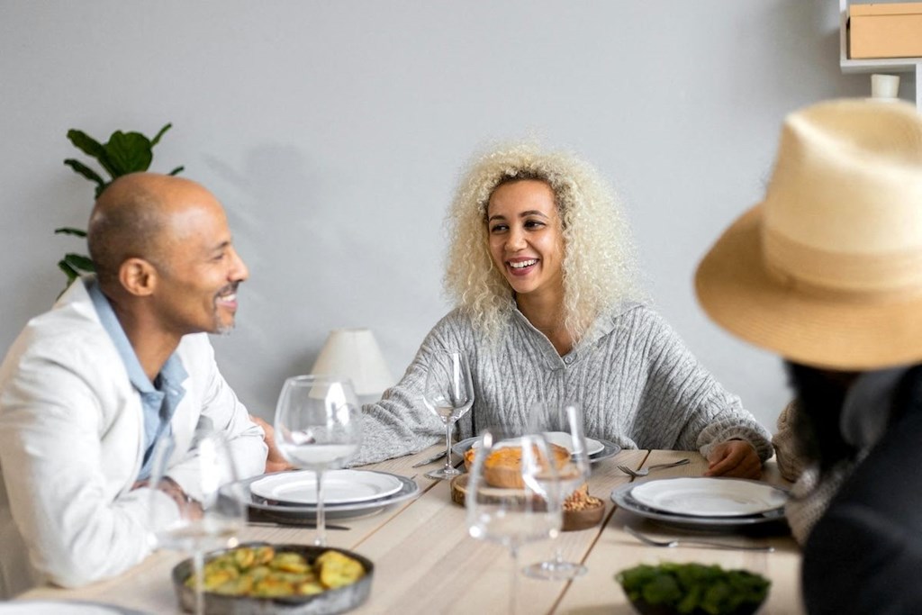 a group of people sitting at a table eating food