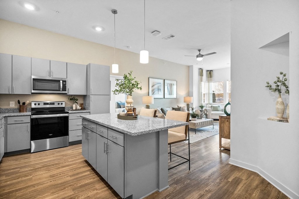 an open kitchen and living room area with a counter top and