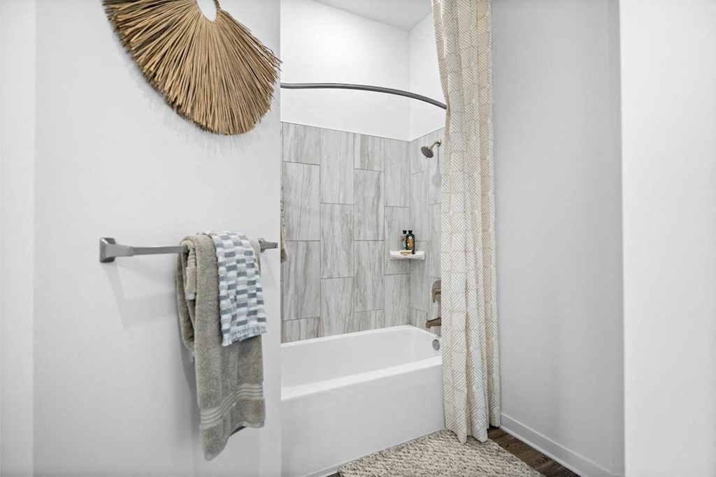 a bathroom with a shower curtain and a bath tub