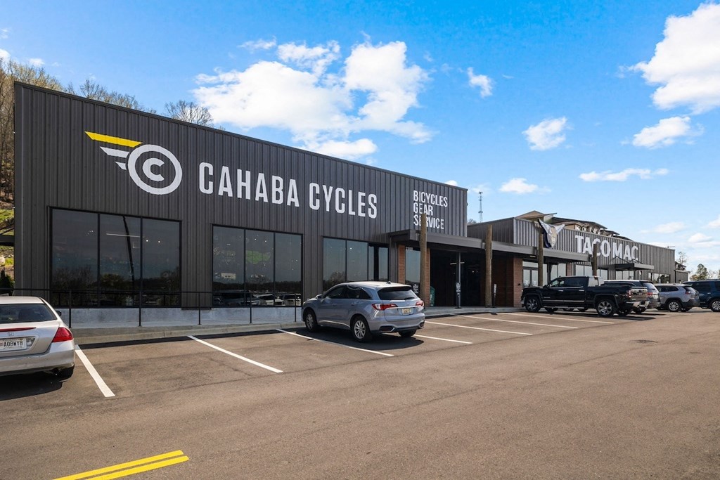 the facade of a building with cars parked in front of it