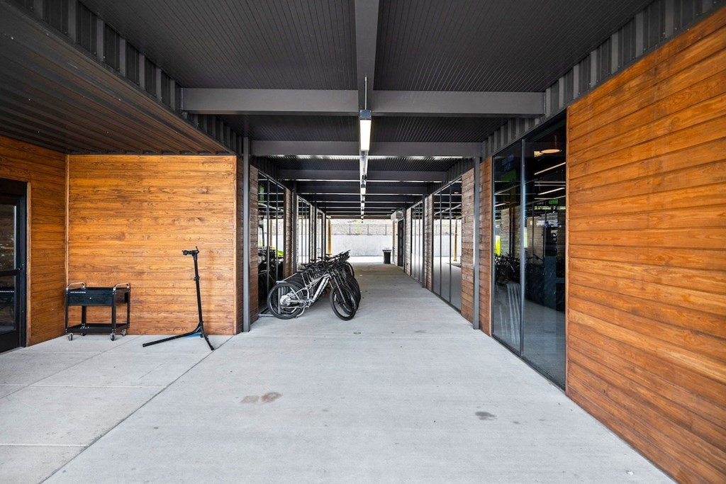 a hallway with wooden walls and bikes parked in the middle