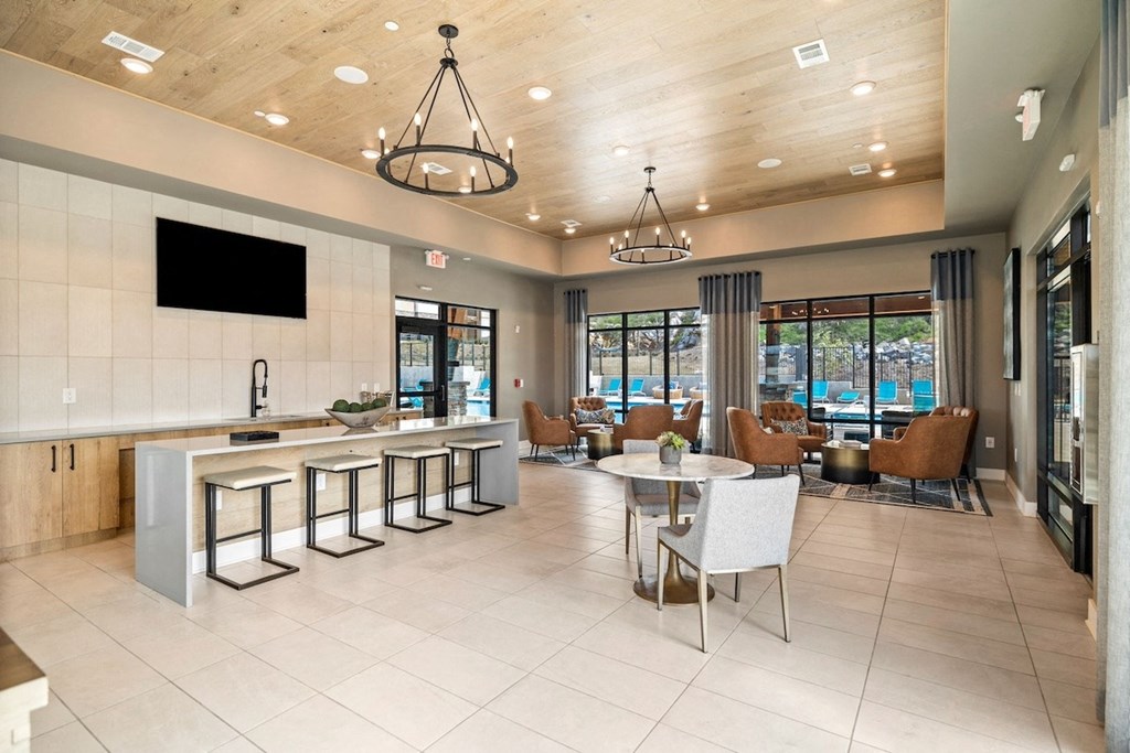 Canopy-Park-Pelham-PG-34 the lobby of a clubhouse with a table and chairs
