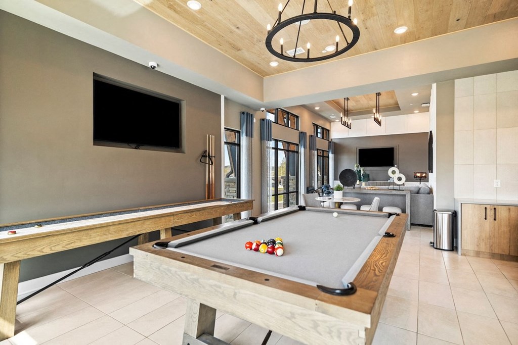 a pool table in a living room with a tv