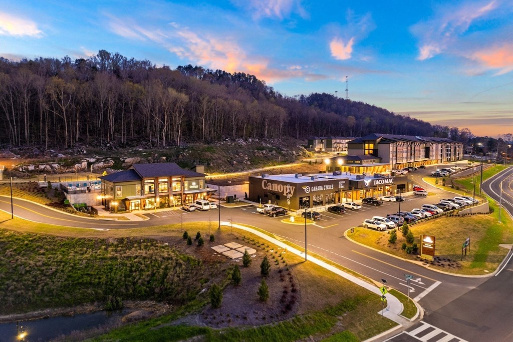 an aerial view of a hotel and parking lot at dusk