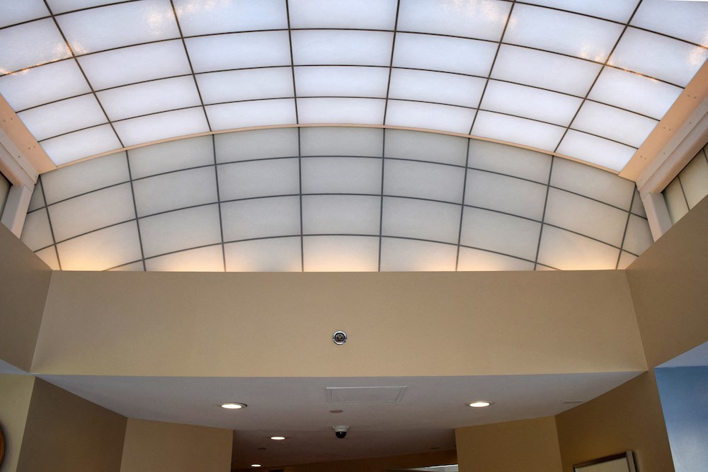 the ceiling of a building with a large domed window