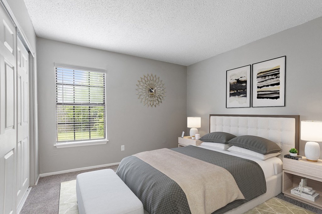 an empty bedroom with a bed and a window