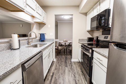 A kitchen with a stainless steel dishwasher and oven.