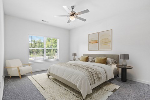 a bedroom with a bed and a ceiling fan