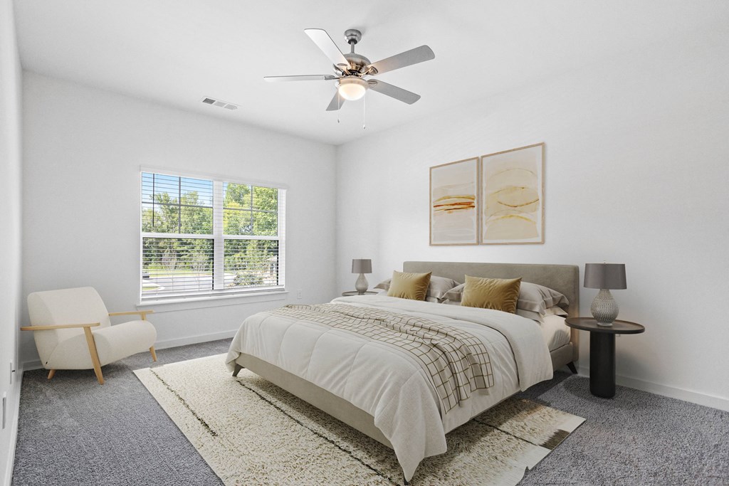 a bedroom with a bed and a ceiling fan
