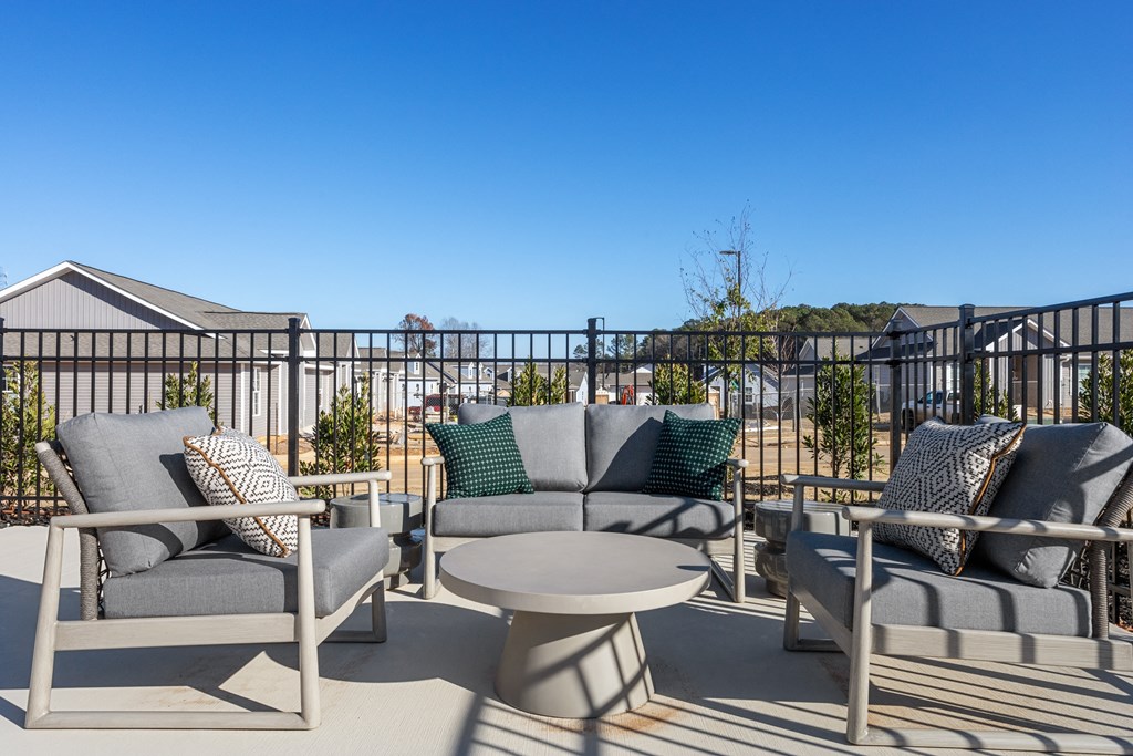 an inviting patio furniture set with sumptuous cushions on the pool deck at Sanctuary at Indian Creek