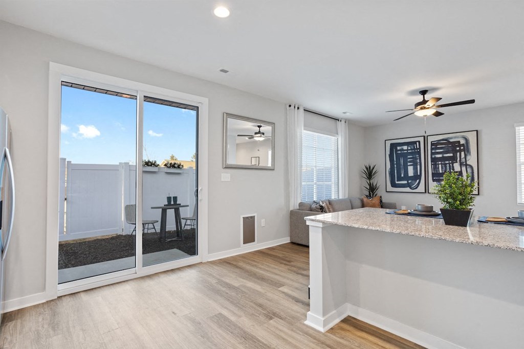 a Sanctuary at Indian Creek rental home living room with large glass sliding doors out to a private back yard 