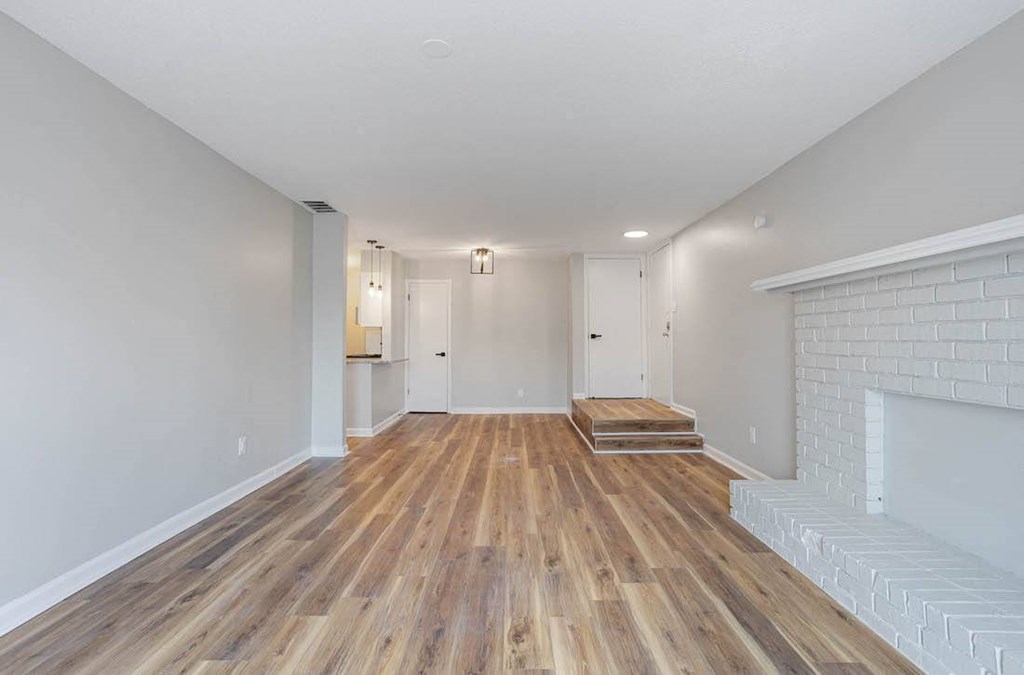 a living room with a fireplace and hardwood-style floors at The Onyx Hoover