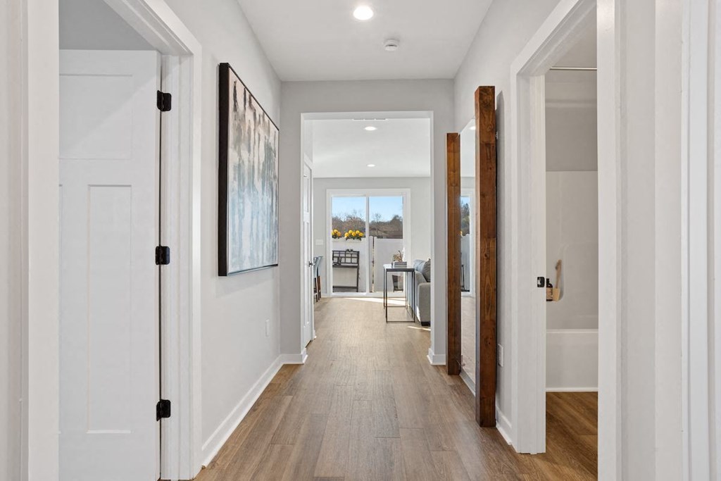 a long hallway with a doors leading to a kitchen and a dining room in a home at Sanctuary at Indian Creek