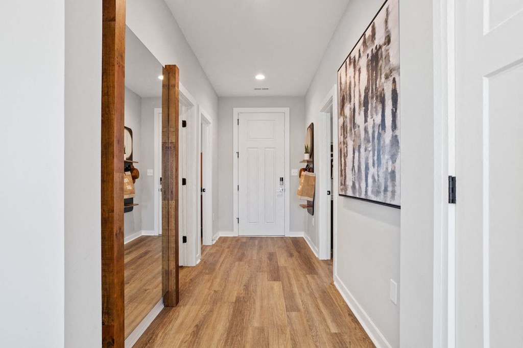 a hallway with white walls and wood-like floors in a Sanctuary at indian Creek Rental Home