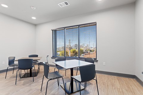 a dining room with a large window and tables and chairs
