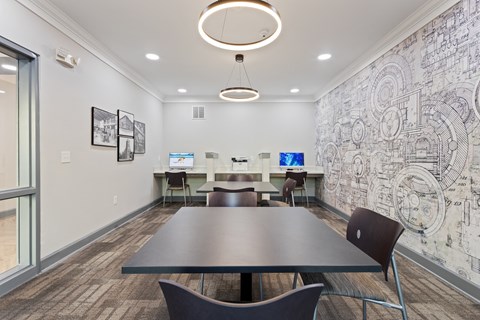 a conference room with a table and chairs and a wall with a mural