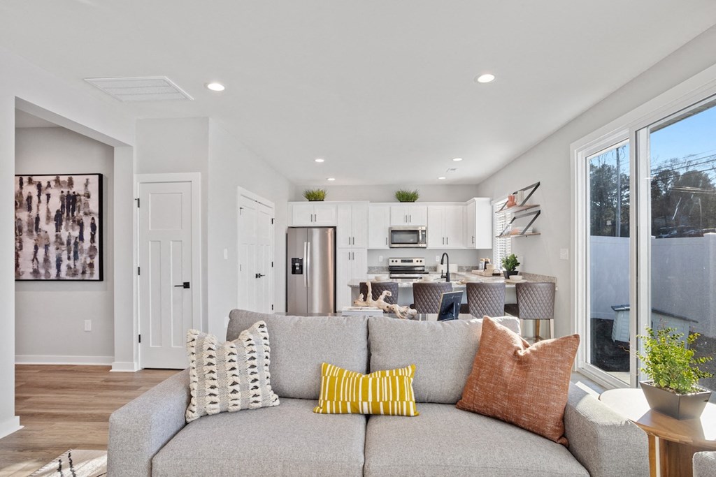 a living room with a couch and a kitchen in the background in a home at Sanctuary at Indian Creek