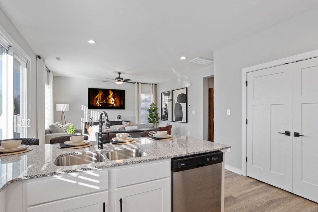 an open kitchen and living room with a fireplace
