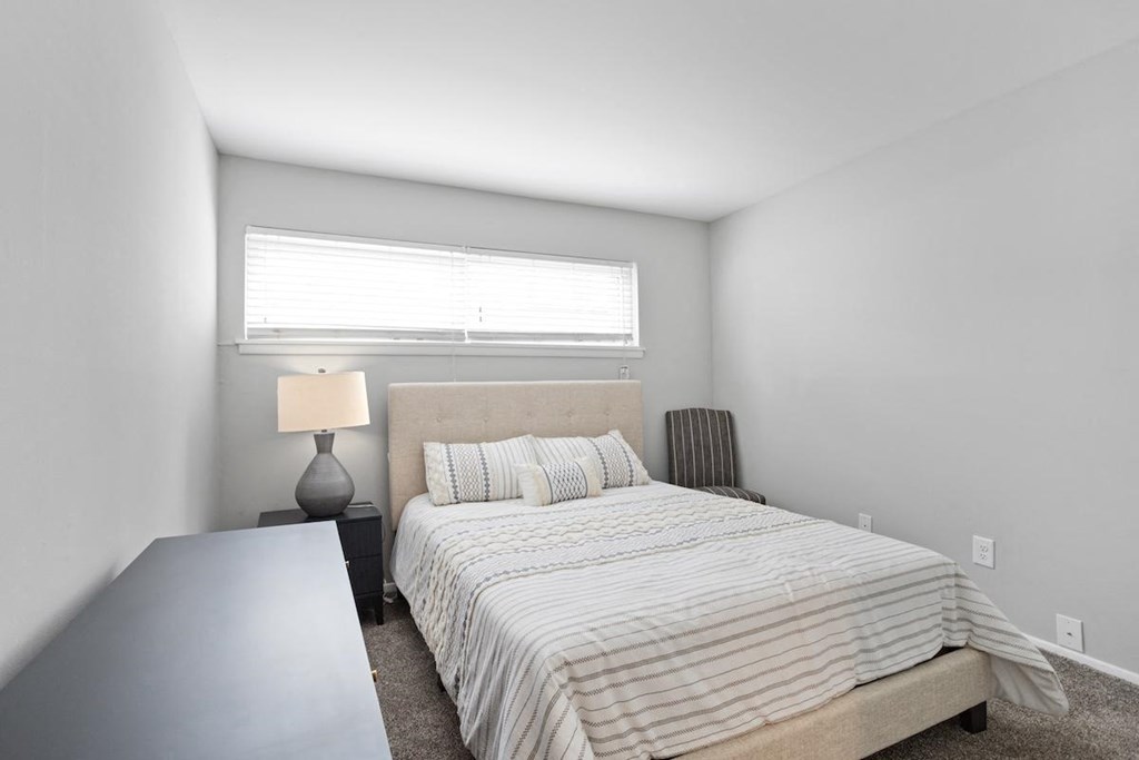 a bedroom with a long narrow window, and furnishings in a Mountainside Apartment in Birmingham, AL
