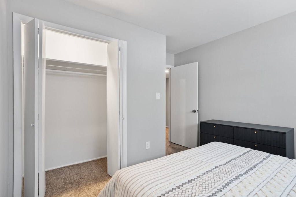 a large closet with a hanging bar and shelf in a bedroom at Mountainside Apartments