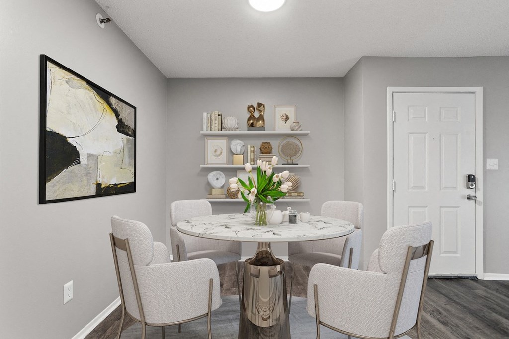 a dining room with white chairs and a table