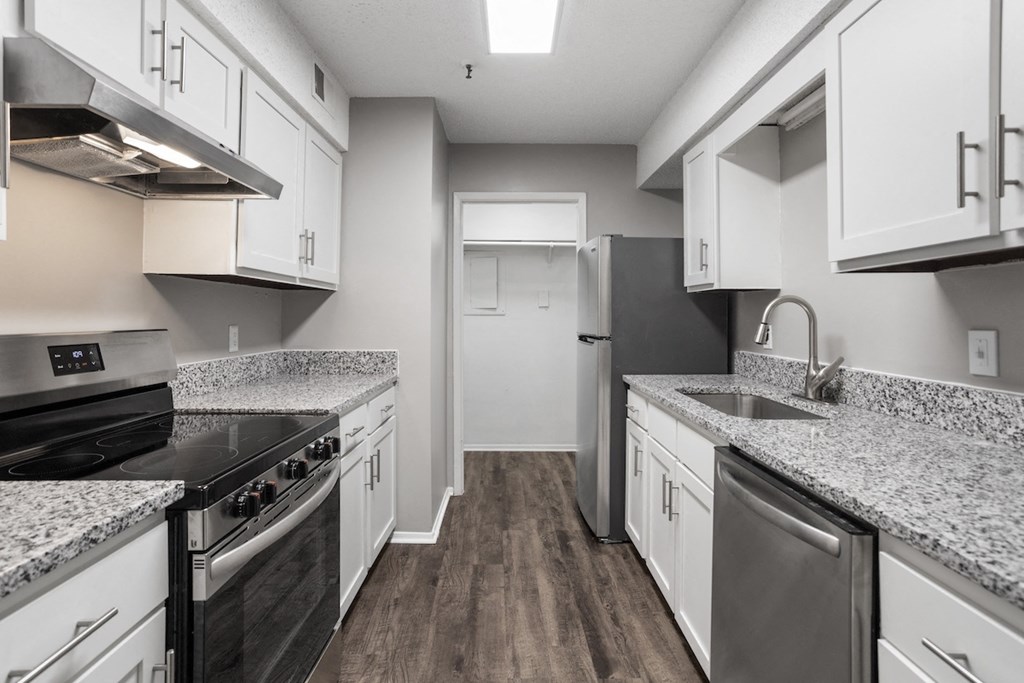 a kitchen with granite counter tops and stainless steel appliances