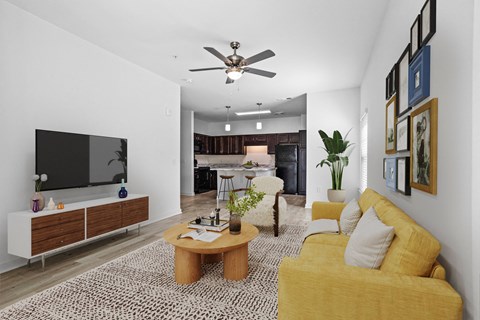 a living room with a yellow couch and a tv