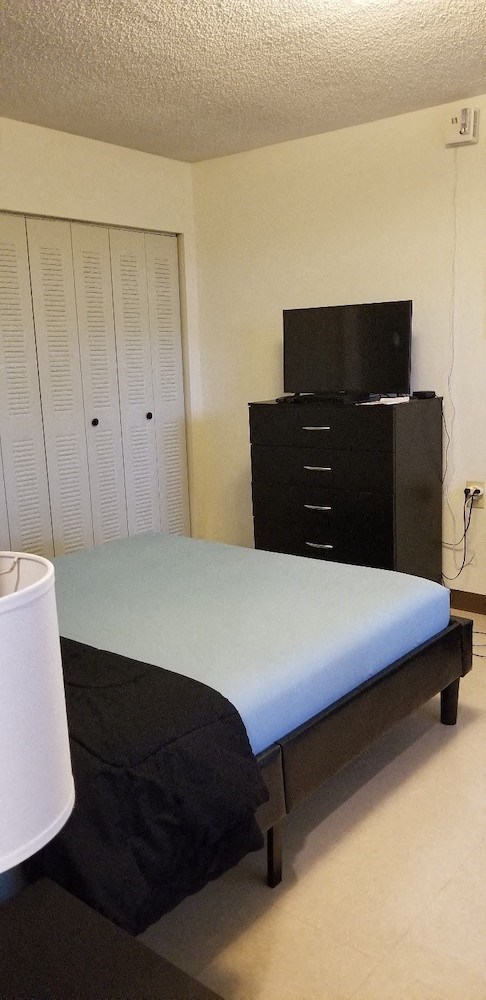 Bedroom with furnishings and closet