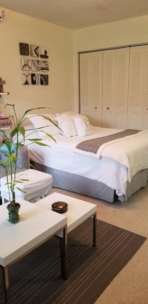 a bedroom with a bed and a coffee table