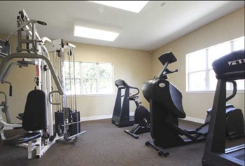 fitness center with cardio and strength training machines - Photo Gallery 7