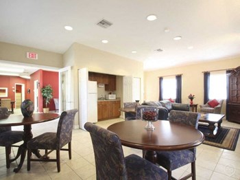 clubhouse interior with comfortable seating area, tables & chairs, and kitchen - Photo Gallery 2