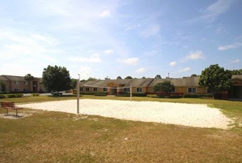 sand volleyball court outside at Country Manor Apartments in Bowling Green, FL - Photo Gallery 10