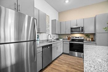 a kitchen with stainless steel appliances and granite counter tops
