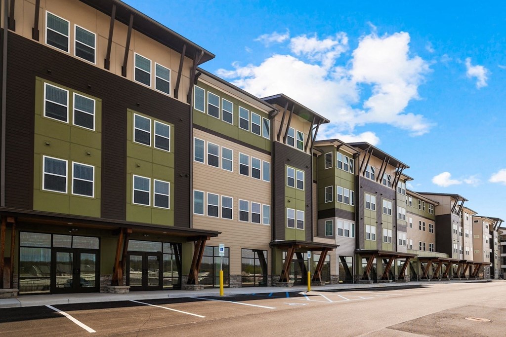 a row of new apartment buildings on the side of a street