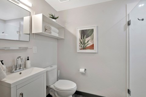 bathroom with sink, toilet, and shower at The Citizen Birmingham in a studio apartment