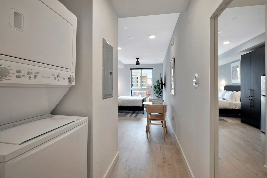 entrance to studio apartment at Citizen Birmingham with combo washer and dryer in nook