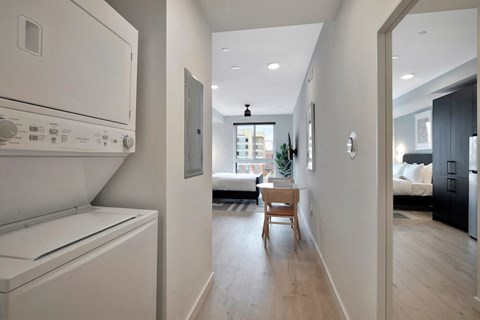 entrance to studio apartment at Citizen Birmingham with combo washer and dryer in nook