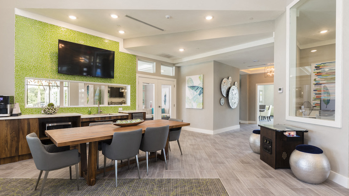 large community table and coffee station in clubhouse
