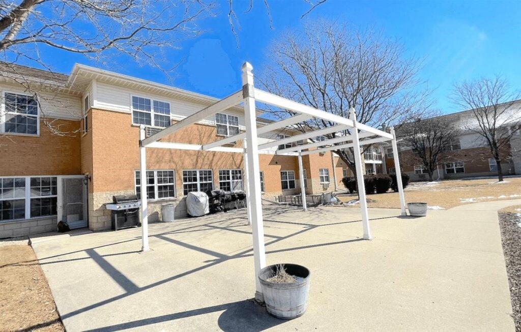 a white awning in the back of Algonquin Manor