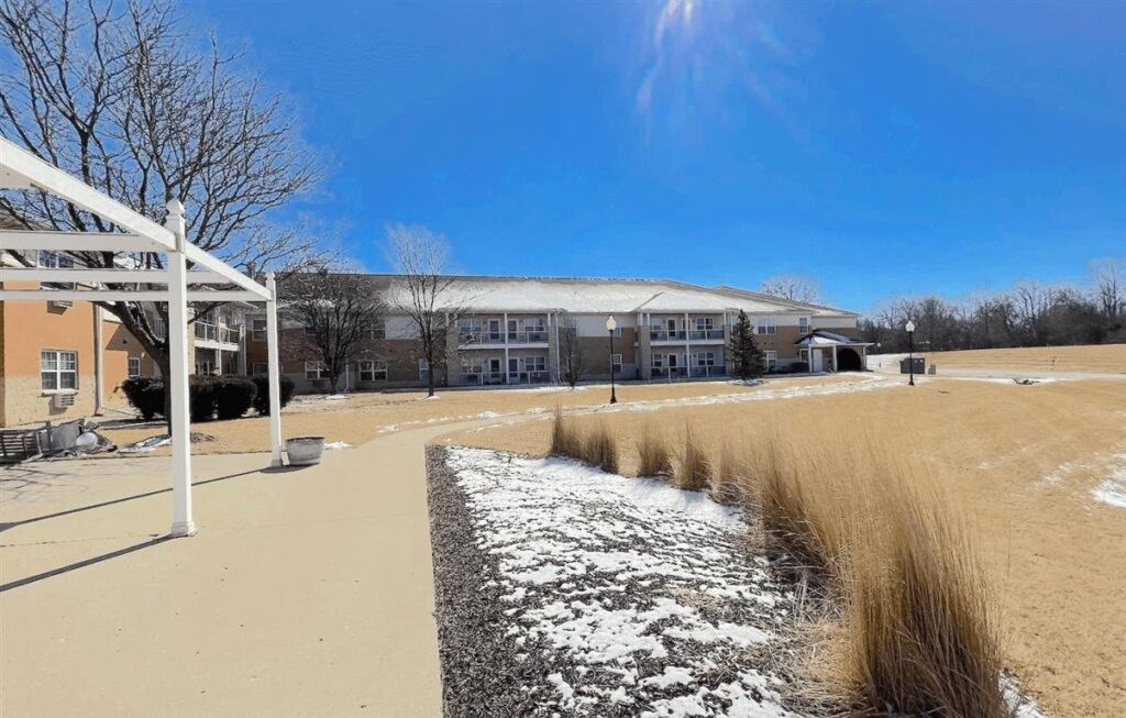a walkway with snow covering the ground at Algonquin Manor
