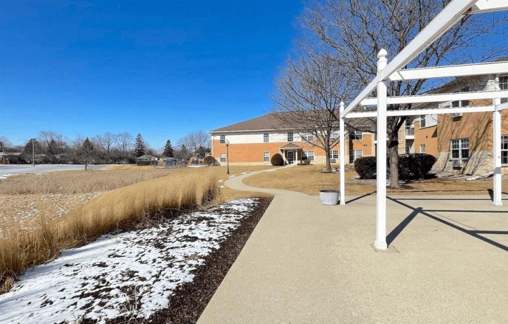 a neat walkway with snow on the ground at Algonquin Manor Senior Apartments