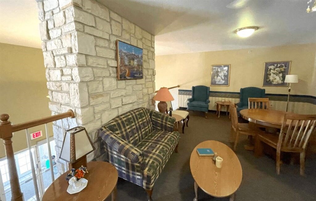 an upstairs sitting area with couches, chairs, and tables at Algonquin Manor